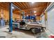 Garage featuring lifts and vehicles undergoing restoration at 228 Indian Creek Rd, Locust Grove, GA 30248