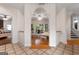 Arched hallway with detailed trim and tile floors provides an elegant transition between rooms at 228 Indian Creek Rd, Locust Grove, GA 30248