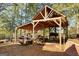 A detached wood outbuilding with partial sides with equipment and ample room for storage at 228 Indian Creek Rd, Locust Grove, GA 30248