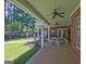 Covered porch featuring comfortable seating, ceiling fans, and a view of the beautifully landscaped yard at 228 Indian Creek Rd, Locust Grove, GA 30248