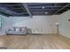 Finished basement with light wood floors, light gray walls, and a comfortable seating area at 2673 Deerfield Sw Cir, Marietta, GA 30064