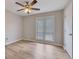 Bedroom with two windows offering natural light, wood-look flooring, neutral walls, and ceiling fan at 2673 Deerfield Sw Cir, Marietta, GA 30064