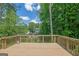 View from deck overlooking the backyard featuring a swimming pool with trees surrounding it at 2673 Deerfield Sw Cir, Marietta, GA 30064