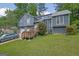 Charming two-story home featuring a blend of siding and stone accents, set amidst a lush green lawn and mature trees at 2673 Deerfield Sw Cir, Marietta, GA 30064