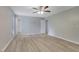 Bright main bedroom with neutral walls, modern ceiling fan, wood-look flooring, and an ensuite bathroom at 2673 Deerfield Sw Cir, Marietta, GA 30064