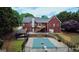 Aerial view of a property with a covered pool, deck, and mature trees at 1118 Sequoia Trl, Mcdonough, GA 30252