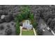 Aerial view of property surrounded by mature trees with a covered pool at 1118 Sequoia Trl, Mcdonough, GA 30252