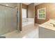 Bathroom features a tub, a glass shower and a double sink vanity at 1118 Sequoia Trl, Mcdonough, GA 30252