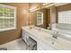 Bathroom featuring a double sink vanity, a window and a jacuzzi tub at 1118 Sequoia Trl, Mcdonough, GA 30252