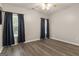Spacious bedroom with hardwood floors, ceiling fan, and natural light from two windows at 1118 Sequoia Trl, Mcdonough, GA 30252