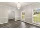 Bright dining room with a modern chandelier, chair railing, and large windows at 1118 Sequoia Trl, Mcdonough, GA 30252