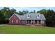 Charming red brick home boasts a lush lawn and mature landscaping at 1118 Sequoia Trl, Mcdonough, GA 30252