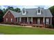 Well-maintained home with a charming front porch and manicured landscaping at 1118 Sequoia Trl, Mcdonough, GA 30252