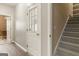 Hallway featuring a staircase, an exterior door with glass panes and an open doorway at 1118 Sequoia Trl, Mcdonough, GA 30252