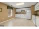 This cozy kitchenette features white appliances and cabinets, perfect for a basement or in-law suite at 1118 Sequoia Trl, Mcdonough, GA 30252