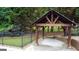 Relaxing poolside pavilion in a backyard setting with lush landscape at 1118 Sequoia Trl, Mcdonough, GA 30252