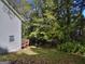Backyard with trees and siding from house at 2066 Tidwell Trl, Stone Mountain, GA 30088