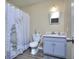 Bright bathroom with a shower/bath combo, white ceramic toilet, and sleek vanity at 2066 Tidwell Trl, Stone Mountain, GA 30088