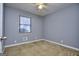 This bedroom features a ceiling fan, carpet and window at 2066 Tidwell Trl, Stone Mountain, GA 30088