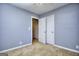 Bedroom with neutral walls, carpet flooring, ceiling fan, and a closet for ample storage at 2066 Tidwell Trl, Stone Mountain, GA 30088