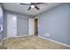 Cozy bedroom with ceiling fan, carpeted flooring, and natural light from the window at 2066 Tidwell Trl, Stone Mountain, GA 30088