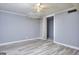 Bedroom with grey walls, ceiling fan and vinyl flooring at 2066 Tidwell Trl, Stone Mountain, GA 30088