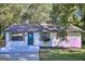 Charming, remodeled single-story home boasts a brick facade, mature trees, and a well-manicured lawn at 2066 Tidwell Trl, Stone Mountain, GA 30088