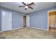 Spacious main bedroom with ensuite bathroom, ceiling fan, and carpeted floor at 2066 Tidwell Trl, Stone Mountain, GA 30088
