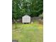 Fenced backyard showing mature landscaping and a storage shed providing a private outdoor space at 1137 Eagles Nest Cir, Carrollton, GA 30116