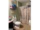 Cozy bathroom featuring a toilet, printed shower curtain, and shelving for linens at 1137 Eagles Nest Cir, Carrollton, GA 30116