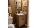 Bathroom with a wooden vanity, white sink, and decorative wall art at 1137 Eagles Nest Cir, Carrollton, GA 30116