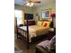 Traditional bedroom with a four-poster bed, dresser, and natural light from a window at 1137 Eagles Nest Cir, Carrollton, GA 30116