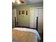 Bedroom showcasing a bed and closet doors in a neutral-toned space at 1137 Eagles Nest Cir, Carrollton, GA 30116
