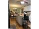 Functional kitchen layout with an island, white cabinets and an open dining area at 1137 Eagles Nest Cir, Carrollton, GA 30116