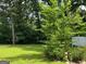 View of backyard featuring lush greenery and a decorative garden accent at 1170 5Th Ave, Jonesboro, GA 30236