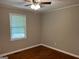 Bedroom with wood floors, a ceiling fan, and a window at 1170 5Th Ave, Jonesboro, GA 30236