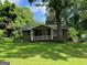 Charming home with a welcoming front porch and a lush green lawn at 1170 5Th Ave, Jonesboro, GA 30236