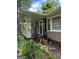 Charming front porch with a covered entrance and black iron railing at 1170 5Th Ave, Jonesboro, GA 30236