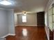 Spacious living room featuring hardwood floors, ceiling fan, and brick fireplace at 1170 5Th Ave, Jonesboro, GA 30236