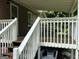 Covered porch showcasing wooden flooring and white railing at 1170 5Th Ave, Jonesboro, GA 30236