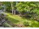 Spacious backyard with lush greenery, a trampoline, and a walking path leading to the house at 770 River Cove Dr, Dacula, GA 30019