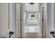 Bright bathroom with a soaking tub, white tile floor, and neutral paint at 770 River Cove Dr, Dacula, GA 30019