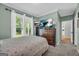 Cozy bedroom featuring neutral décor, television, carpet, and backyard view at 770 River Cove Dr, Dacula, GA 30019