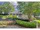 View of the community clubhouse and landscaped lawn, with seating and lounge chairs at 770 River Cove Dr, Dacula, GA 30019