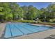 The large community pool features blue lane markers, a slide, a lifeguard chair, and plenty of seating at 770 River Cove Dr, Dacula, GA 30019