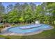 View of a community pool with a shallow water section, lifeguard stand and surrounding seating at 770 River Cove Dr, Dacula, GA 30019