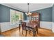 Elegant dining room featuring a wooden table, chandelier, and wainscoting at 770 River Cove Dr, Dacula, GA 30019
