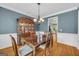 Dining room with hardwood floors features china cabinet, table with chairs, and chandelier at 770 River Cove Dr, Dacula, GA 30019