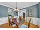 Traditional dining room with hardwood floors, blue walls, and decorative accents at 770 River Cove Dr, Dacula, GA 30019