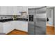 Bright kitchen showcases stainless steel appliances, white cabinets and stylish tile backsplash at 770 River Cove Dr, Dacula, GA 30019